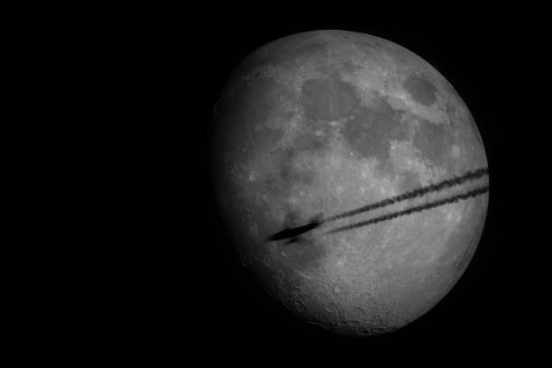 Airplane Silhouette Silhouette of an airplane and its contrails in front of the moon as seen from Wachenheim in Germany. contrail moon on a night sky stock pictures, royalty-free photos & images