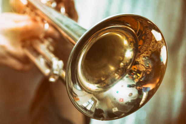 Trumpeter is playing on a silver trumpet