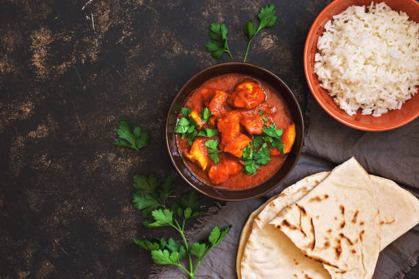 istock Chicken tikka masala with rice. Indian food. Top view, copy space. 963391274