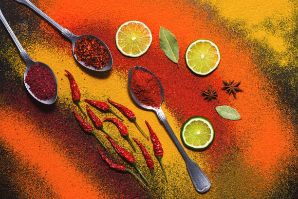 istock Background of bright various spices with spoons. Fire their chilli peppers. The view from above, flat lay. 963391492