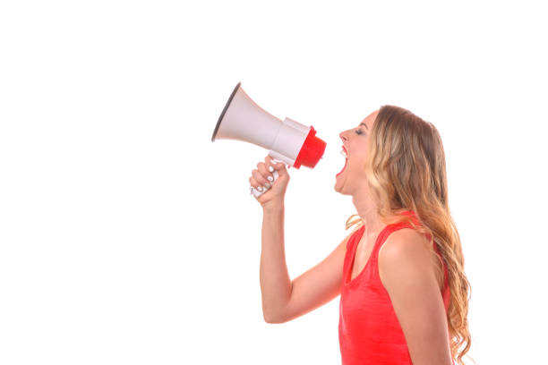 istock Young blond woman shouting into a megaphone 963394726
