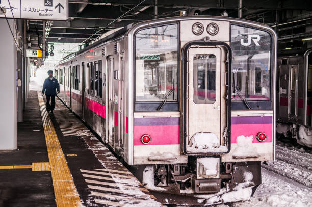 rosa streifen jr east 701-serie commutor zug in hirosaki station im winter trainieren emu alarmkontakt auf ou hauptlinie zwischen akita und aomori - opperated stock-fotos und bilder