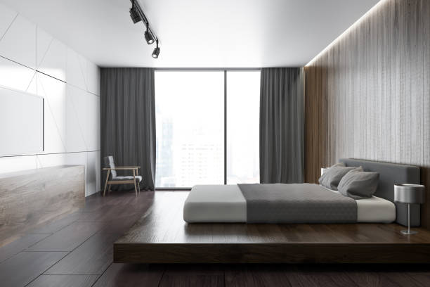 istock White wooden loft bedroom with a TV set, side view 963396790