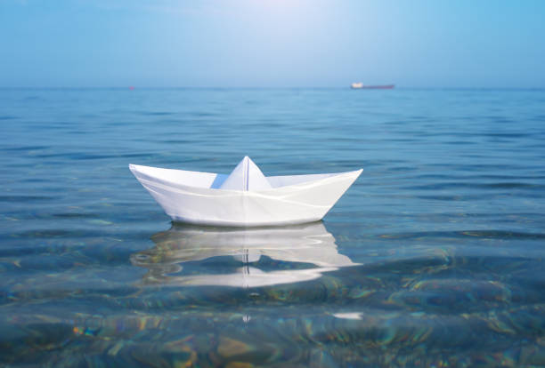 Paper toy ship and deep blue sea. Conceptual design.