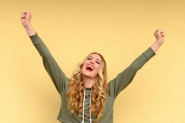 istock Elated joyful young woman cheering 963397472