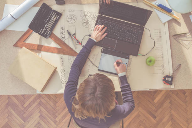 istock Female architect in a bright sunny room working on a project. 963399028