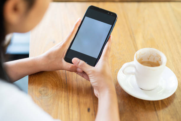 istock Play the mobile phone and drinking coffee in the morning. 963402442