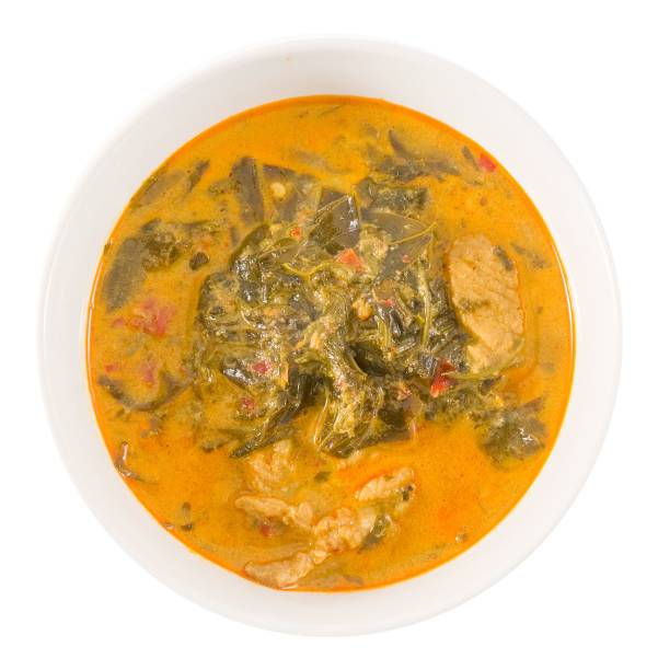 istock Top View Coconut Milk Curry with Cassia Leaves on White 963415998