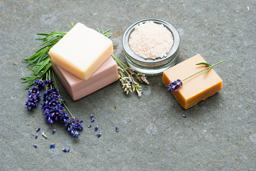 lavender flowers and soap samples, bath salt on basalt stone background