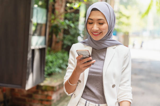 istock Malaysian woman reading messages on smart phone 963421870