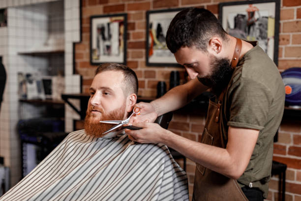 istock Barber and bearded man in barber shop 963422840