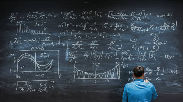 istock Brilliant Young Mathematician is Finishing Writing Complex Equation on the  Blackboard. 963424248