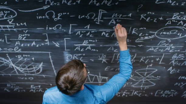 istock High-Angle Shot of a Brilliant Young Student Writing Complex Mathematical Formula/ Equation on the Blackboard. 963424562