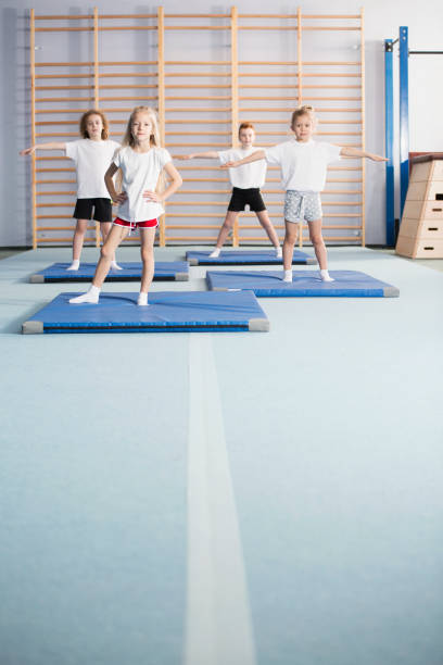 istock Warm-up exercises in school gym 963424676