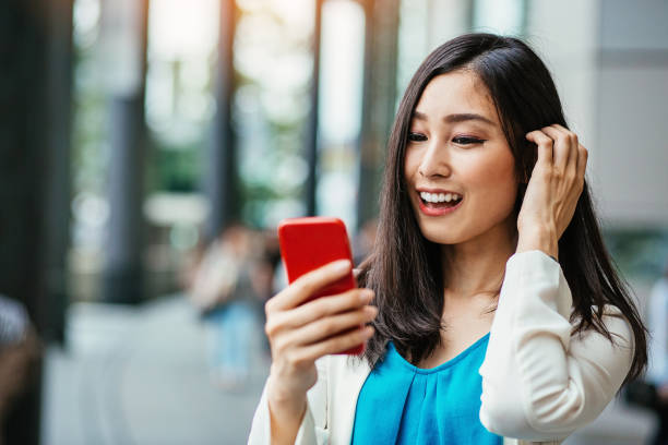 istock Japanese girl looking at mobile phone 963427870