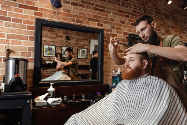 istock Barber and bearded man in barber shop 963431442