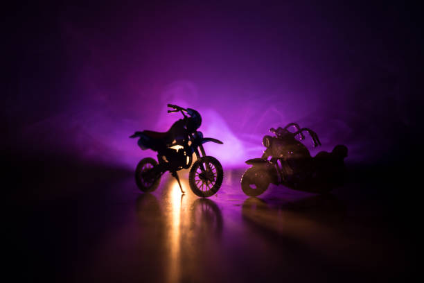 istock High power motorcycle chopper. Fog with backlights on background with man rider at night. Empty space 963437910