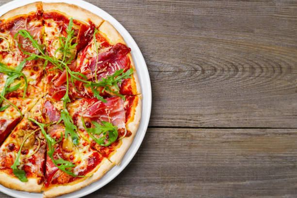 istock Italian prosciutto and arugula pizza, copy space 963438200