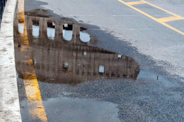 istock Colosseum reflected on wet road : Rome, Italy 963440220