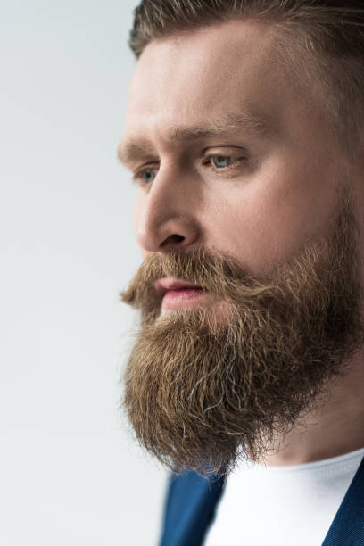 istock Handsome man with stylish beard and mustache isolated on light background 963443040