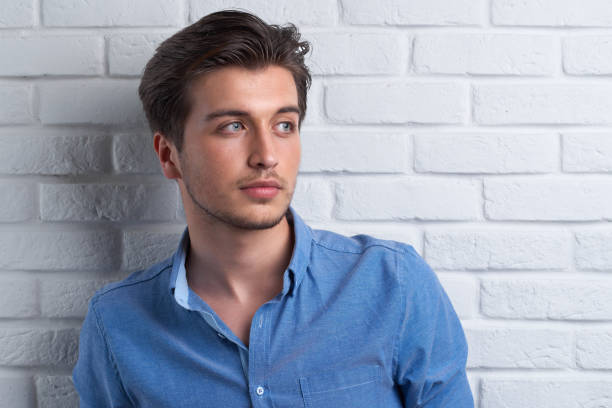 istock man is staying on the brick background in the studio 963443620