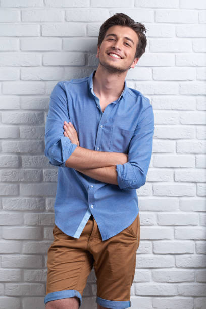 istock man is staying on the brick background in the studio 963444052
