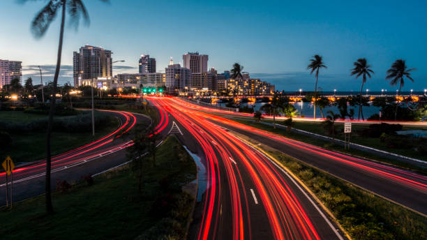 Welcome to San Juan. Road leading to the capital of Puerto Rico at night. puerto rico photos stock pictures, royalty-free photos & images