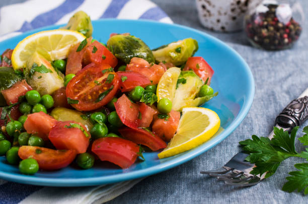 Salad with raw slices of vegetables Salad with raw slices of vegetables in a dish on the table. Selective focus. kosher starter recipes stock pictures, royalty-free photos & images