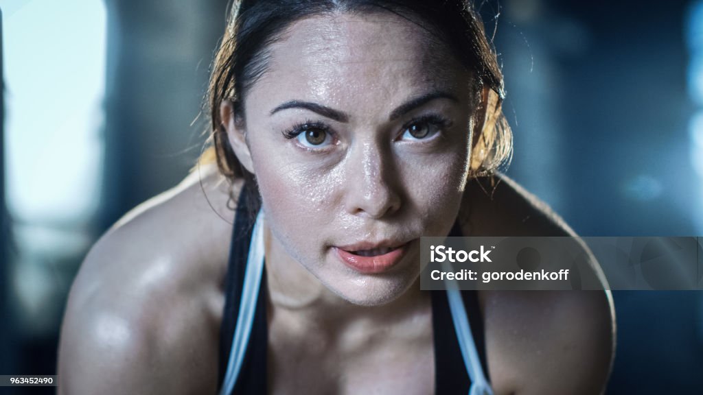 Shot of a Beautiful Athletic Brunette Resting on the Bench and Smiling into the Camera. Close-up Stock Photo