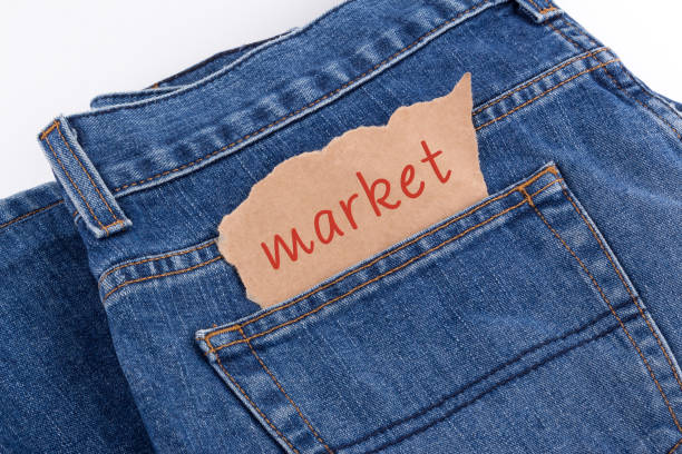 Happy sisters selecting and buying jeans together from outdoor street market of Delhi, India at day time.