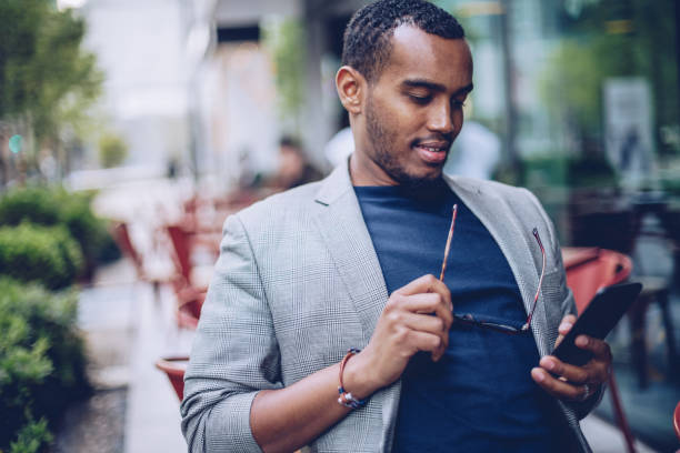 istock Man in coffee shop texting on phone 963453214