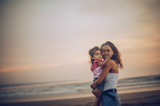 istock Mother and daughter at the beach 963454362