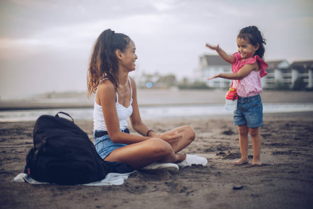 istock Young mother and daughter at the beach 963455254