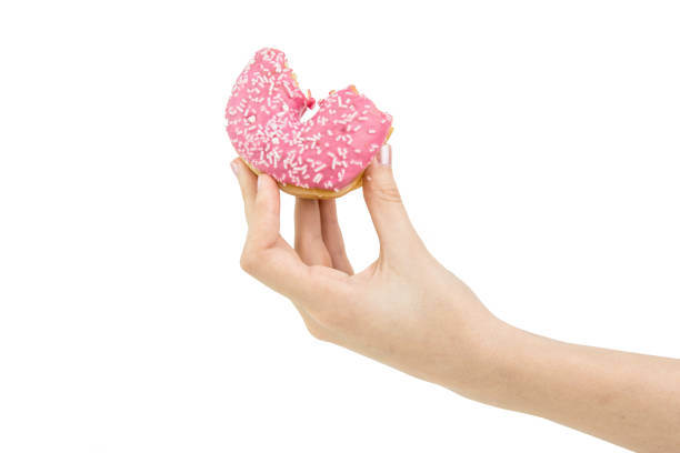 istock Hold Handing Delicious Pink Bitten Donut With Pink Cream Inside. Isolated 963455744