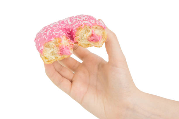istock Hold Handing Delicious Pink Bitten Donut With Pink Cream Inside. Isolated 963457782