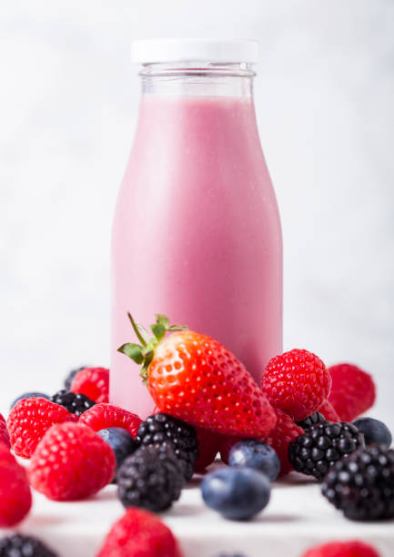 istock Glass bottle with fresh summer berries smoothie 963460122