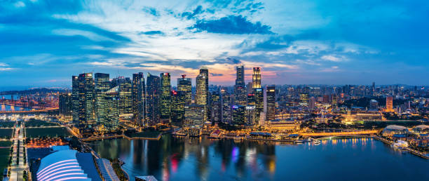 istock Singapore skyline at sunset 963463322