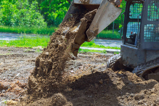 istock Close up view of medium size bulldozer levels recently dumped earth 963463730