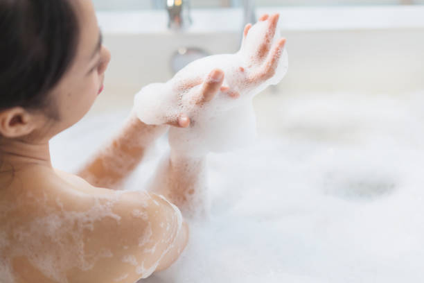 istock Women's feet she was bathing in a a bathtub with happiness 963506526
