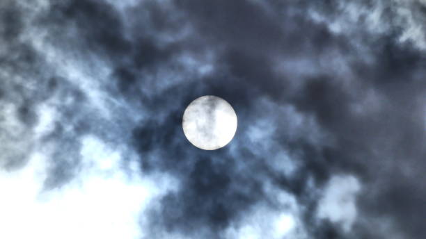 istock The sun behind the gray and white clouds 963506756