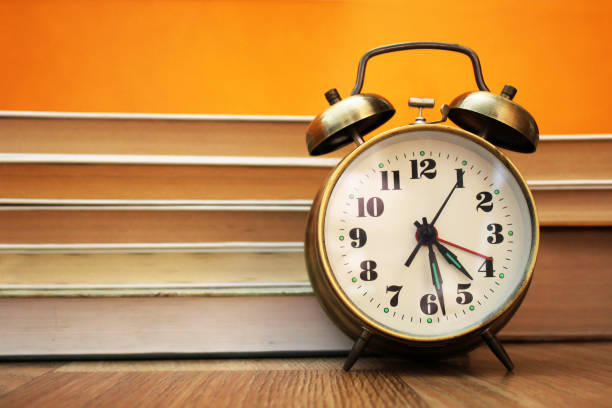 istock Retro alarm clock and books 963509574