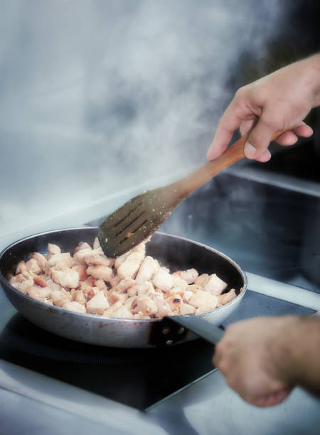 istock Man mixing meat in a pan on the stove 963509776