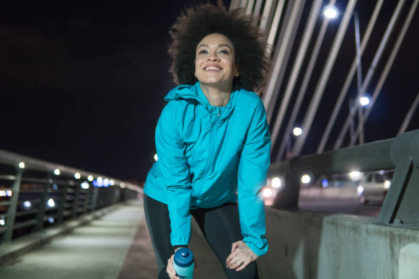 istock Happy female jogger with water bottle in her hand 963529250