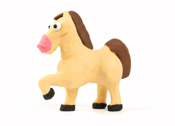 istock Cute horse modeling clay isolated on white background. Handmade plasticine. Side view. Close up. 963532460