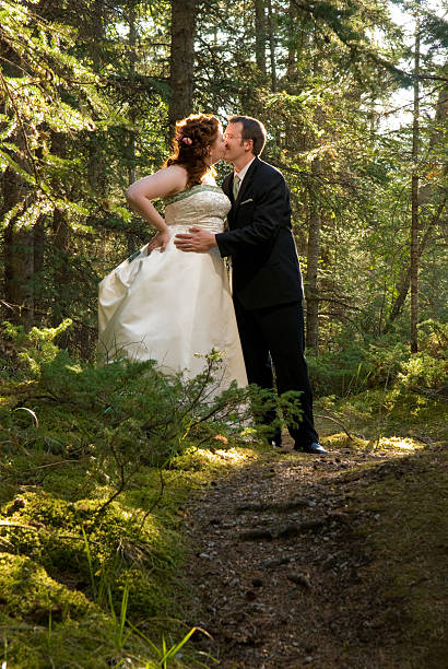 istock Bride and Groom Kissing in Forest 96355706