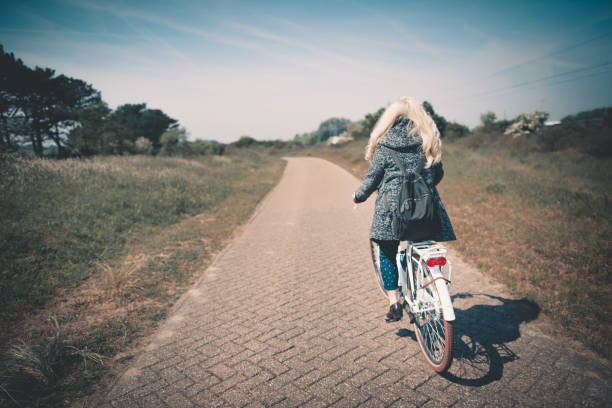 istock asian chinese female riding on bicycle 963558626