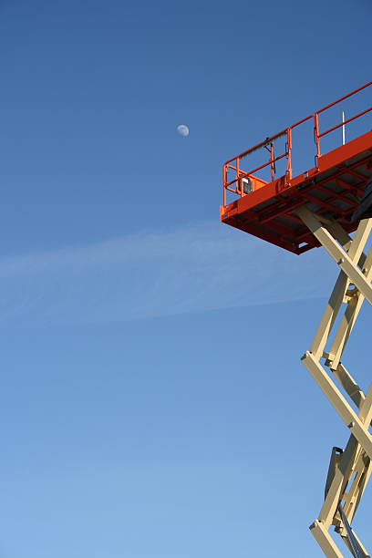 istock 'cherry picker' extended in air moon above blue sky 96359393