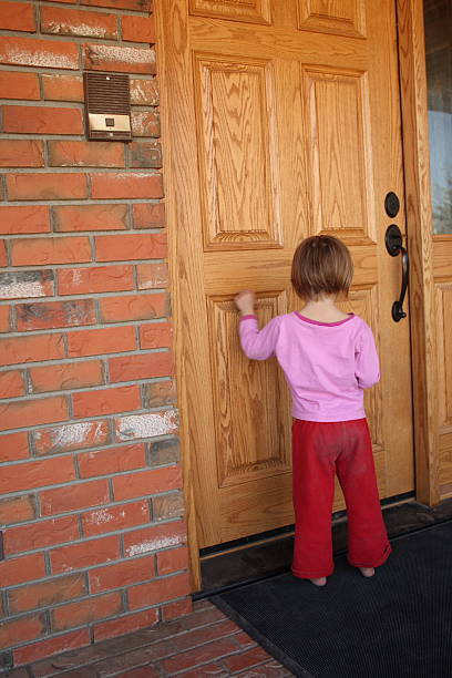 istock little girl knocks on large oak  door 96360107