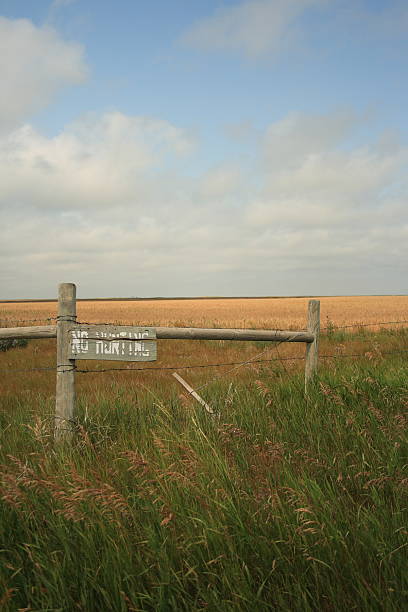 istock old 'no hunting' sign on a Southern Alberta field 96360266