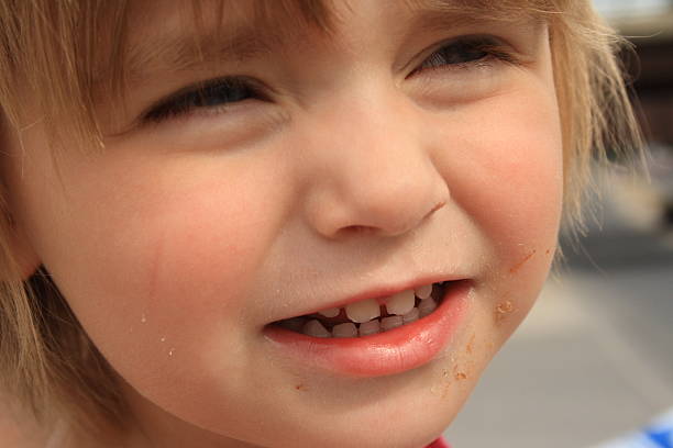 istock little girl close-up squints - dirty face 96360395